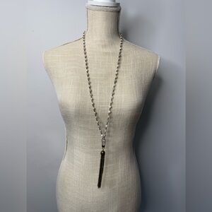 Long white beaded necklace with gold chain tassels